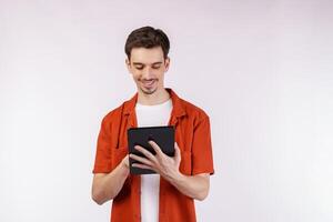 Portrait of attractive cheerful man using device app searching web isolated over white color background photo
