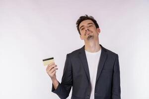 Portrait of unhappy businessman showing credit card isolated over white background photo