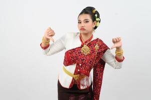 Young beautiful woman in Thai lanna costume with thumb down posture photo