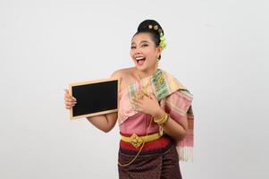 Young beautiful woman in northeastern dress holding chalkboard posting photo