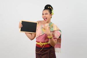 Young beautiful woman in northeastern dress holding chalkboard posting photo