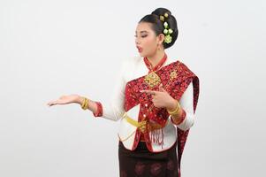 Young beautiful woman in northeastern dress stand and open palm posture photo