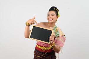 Young beautiful woman in northeastern dress holding chalkboard posting photo