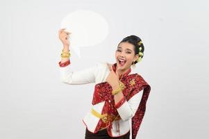 Young beautiful woman in Thai lanna costume with blank speech bubble sign photo