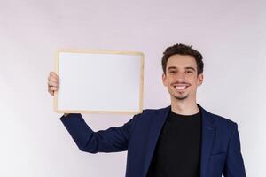 Portrait of happy businessman showing blank signboard on isolated white background photo