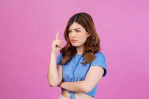 Portrait of young woman wearing casual t-shirt thinking and imagination isolated over pink background photo