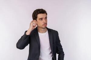 Portrait of thinking man surrounded by question mark on isolated background photo
