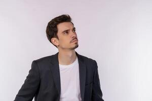 Portrait of thinking man surrounded by question mark on isolated background photo