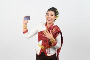 Young beautiful woman in northeastern dress show credit card posture photo