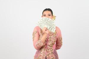 Young beautiful woman dress up in local culture in southern region pose with banknote photo