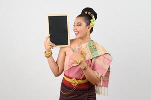 Young beautiful woman in northeastern dress holding chalkboard posting photo