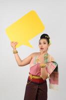 Young beautiful woman in Thai lanna costume with blank speech bubble sign photo