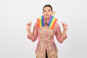 Young beautiful woman dress up in local culture in southern region with rainbow flag photo