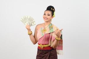 Portrait of Beautiful Thai Woman in Traditional Clothing Posing with fan Banknote photo