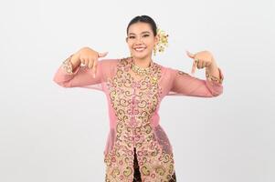 Young beautiful woman dress up in local culture in southern region point finger posture photo