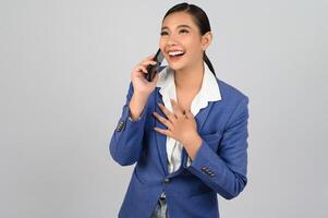 Young beautiful woman in formal clothing for officer use smartphone posture photo