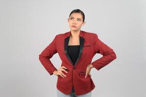 Young beautiful woman in formal officer costume thinking on white background photo