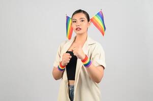 Pretty woman LGBQ pose with mini muli-color flag photo