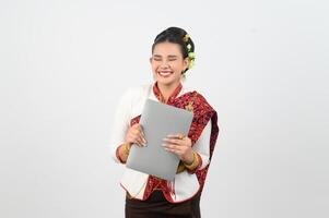 Portrait of Beautiful Thai Woman in Traditional Clothing Posing with laptop computer photo