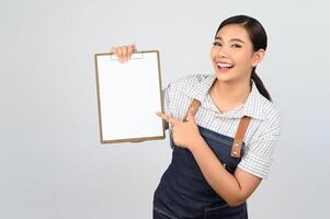 Portrait of young asian woman in waitress uniform pose with clipboard photo