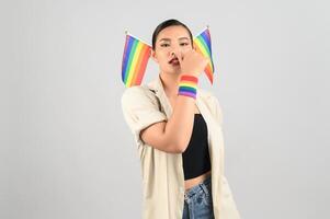 Pretty woman LGBQ pose with mini muli-color flag photo