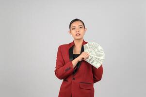 Young beautiful woman in formal clothing for officer with banknote in hands photo