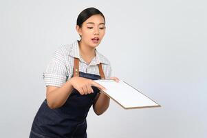 Portrait of young asian woman in waitress uniform pose with clipboard photo