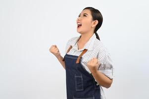 Pretty successful young woman shouting and raised hands with happy photo