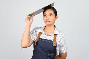 Portrait of young asian woman in waitress uniform pose with clipboard photo