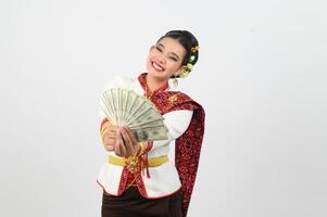 Portrait of Beautiful Thai Woman in Traditional Clothing Posing with fan Banknote photo