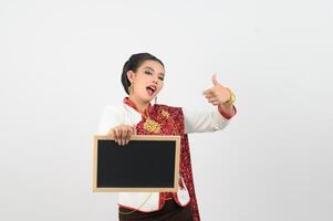 Portrait of Beautiful Thai Woman in Traditional Clothing Posing with blackboard photo