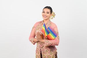 Young beautiful woman dress up in local culture in southern region with rainbow flag photo