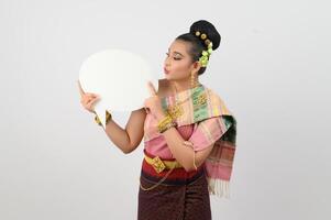 Young beautiful woman in Thai lanna costume with blank speech bubble sign photo