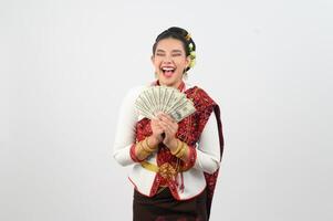 Young beautiful woman in northeastern dress holding fan banknote posting photo