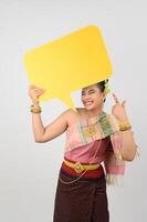 Young beautiful woman in Thai lanna costume with blank speech bubble sign photo