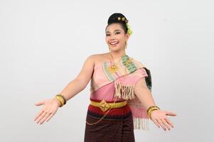 Young beautiful woman in northeastern dress stand and open palm posture photo