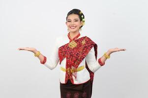 Young beautiful woman in northeastern dress stand and open palm posture photo