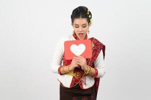 Young beautiful woman in Thai lanna costume with card card in heart symbol photo