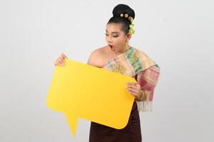 Young beautiful woman in Thai lanna costume with blank speech bubble sign photo