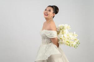 Young asian beautiful bride pose with excited feel on white background photo