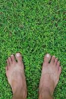 Feet on Green Field of Lawn for Concept Background photo