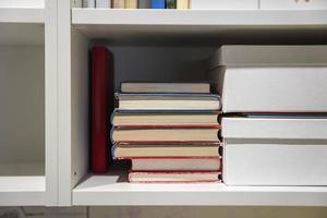 home bookshelf with books, textbooks and folders photo