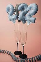 inflatable figures with the numbers 2022 in champagne glasses photo