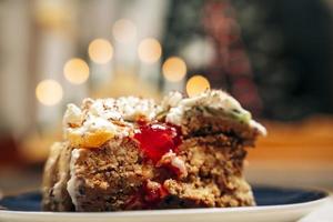 A piece of delicious beautiful cake decorated with cream and banana slices photo