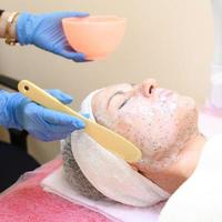 Spa facial mask application. Spa beauty organic facial mask application at day spa salon photo