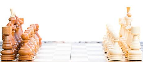 Chess board set up to begin a game on white photo