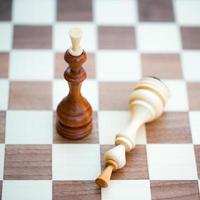Two chess pieces alone on a chess board photo