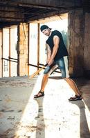 Man with baseball bat on the ruins photo