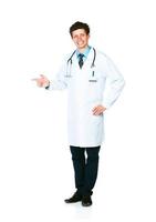 Portrait of a smiling young male doctor pointing sideways on white photo