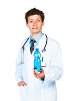 Portrait of a male doctor holding bottle of water on white photo